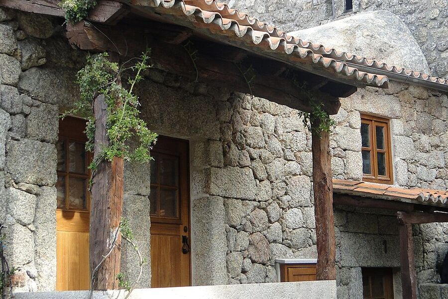Granite cottage with a vine over the door